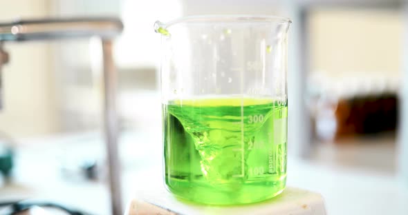 Mechanical Stirring Liquid of Green Color is Mixed in a Round Flask