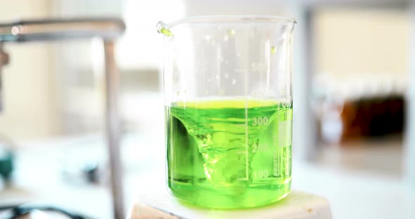 Mechanical Stirring Liquid of Green Color is Mixed in a Round Flask alt
