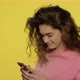 Young Woman Using Mobile Phone on Yellow - VideoHive Item for Sale