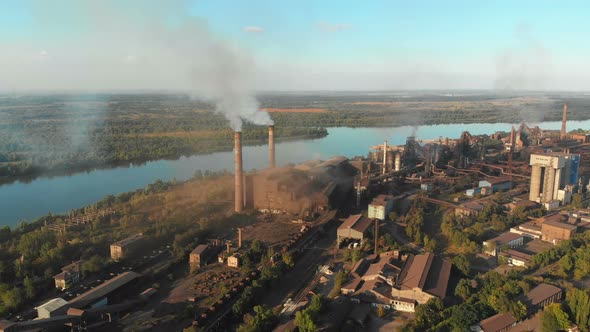 Aerial View of the Industrial Plant with Smoking Pipes Near the City. Industrial Zone alt