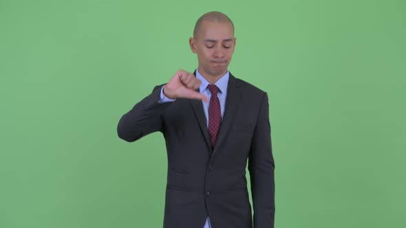 Angry Bald Multi Ethnic Businessman Giving Thumbs Down alt