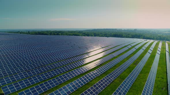 Aerial View of Solar Energy Farm Located on Green Field alt