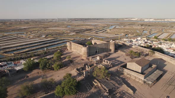 Aerial dolly out showcasing medieval Castle of Castro Marim and the remains within fortification alt