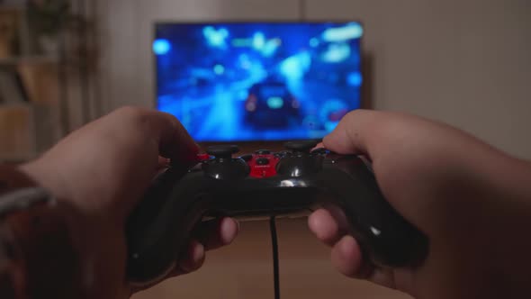 Hands Gamer Playing Car Race Game On Tv alt