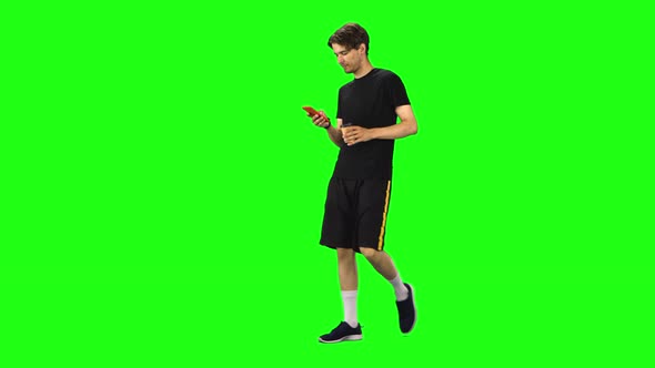 Brunette Man Walking and Watching on the Phone Something, Drinking Coffee. Chroma Key alt