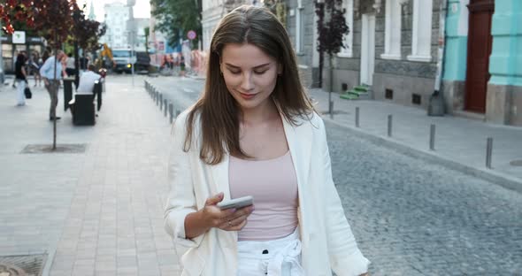 Happy, Smiling, Beautiful, Young Woman Walks Through the City on Shopping with Purchases in the alt