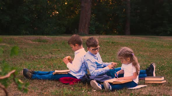 Relaxing Schoolboys Wearing Shirts Sit Near Writing Girl alt