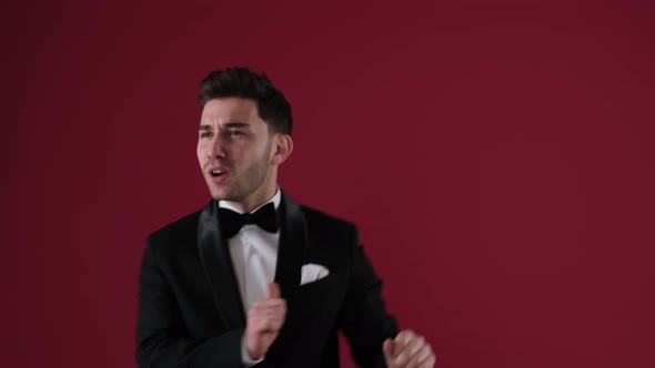 Handsome Man in Tuxedo Dancing to Music alt