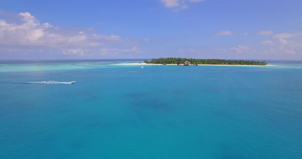 Aerial drone view of a scenic tropical island in the Maldives. alt