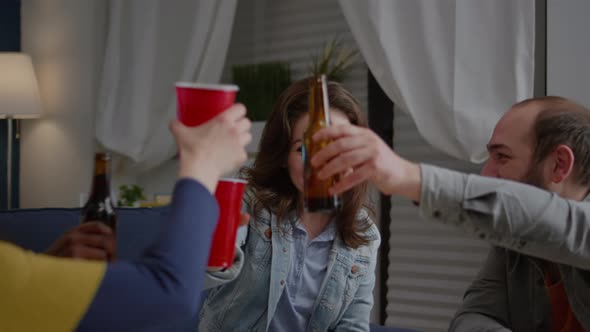 Multiethnic Friends Gathering Late at Night in Living Room While Resting on Sofa alt