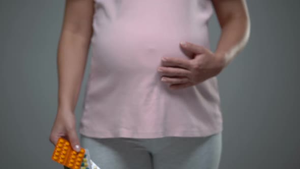 Pregnant Woman Holding Many Tablets, Harm of Medicines, Vitamins for Women