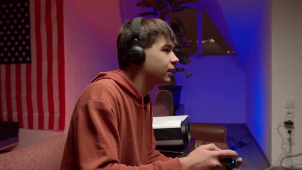 Young Man in Headphones Playing Video Game