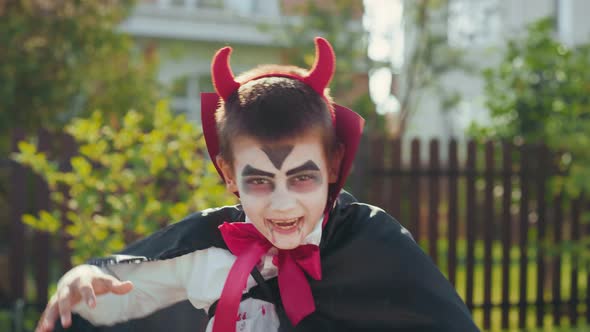 Cute Boy Posing in his Halloween Costume alt