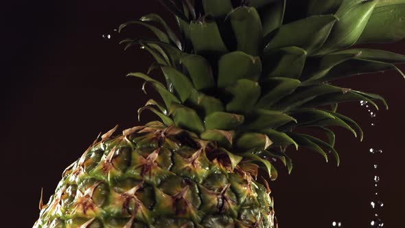 Super Slow Motion Water Drips on Rotating Pineapple alt