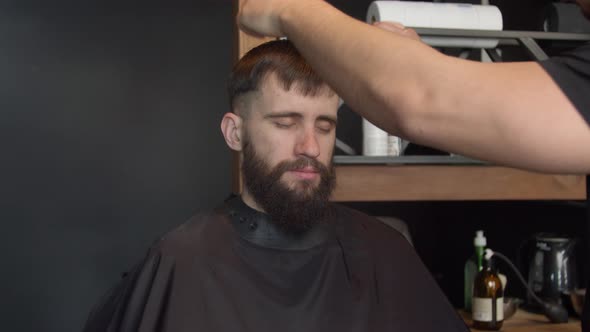 Barber Cutting Hair of Male Client