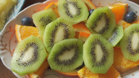 Fruit Slices of Kiwi Orange and Berries Beautifully Arranged on a Plate