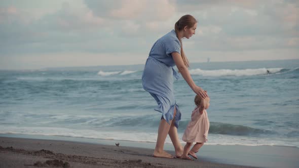 Mom Showing Baby Ocean Waves alt