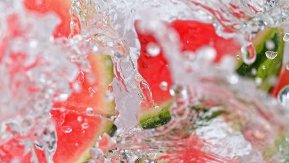 Super Slow Motion Shot of Melon Slices Falling Into Water Whirl at 1000 Fps alt