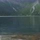 Slow motion footage of raindrops falling into a mountain lake. Hiking in the mountains - VideoHive Item for Sale