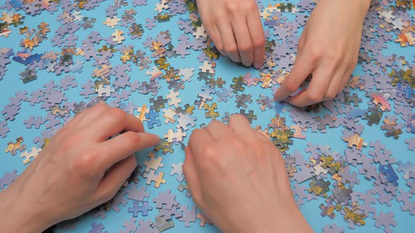 Assembling Jigsaw Puzzle. Hand Matching Jigsaw Halves. Leisure Activity. Achieving Step By Step Love