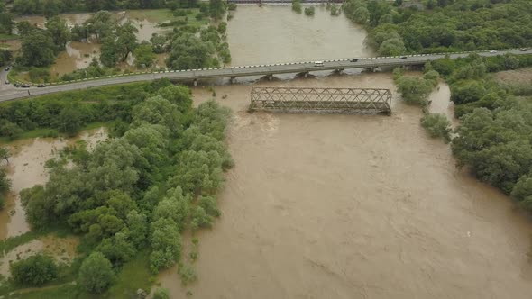 Aerial View of the Bridge During Floods. Extremely High Water Level in the River.