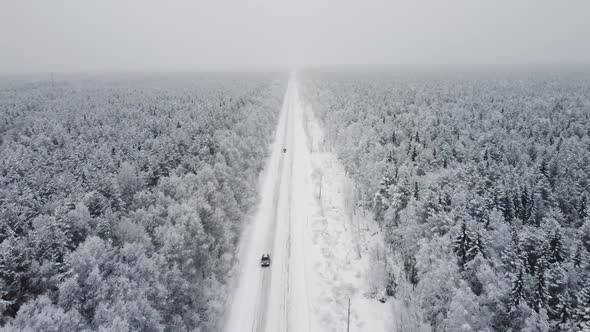 Aerial Top View From Drone Birds Eye View of Winter Landscape and Snowy Ice Road Car Moving on Area