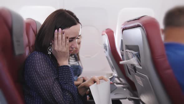 Woman on the Plane Vomited in a Paper Bag