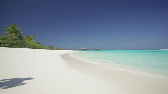 Young Couple Running Into Waves alt