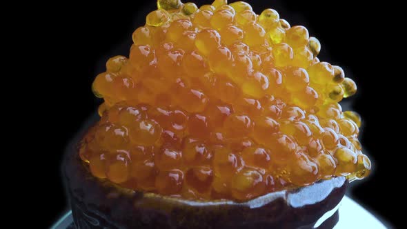 Red Caviar Is Put with a Spoon on Tartlets. Preparation of Snacks with Red Caviar. Close Up