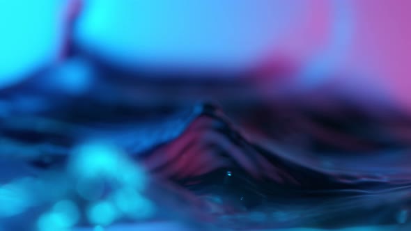 Super Slow Motion Abstract Shot of Swirling Neon Water at 1000Fps alt