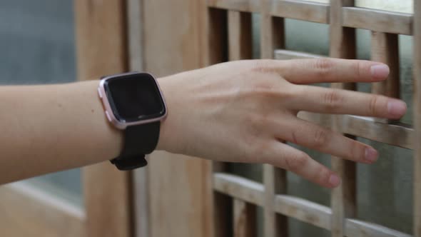 Close up hands young girl touching softly door a small street enjoying vacation summer. alt