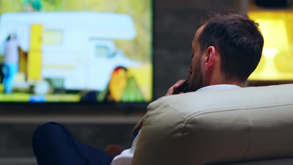 Back View of Businessman Taking a Sip of Beer alt