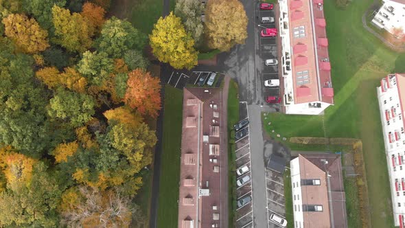 Fall Foliage and Apartment Building Roofs Top Down Aerial Forward