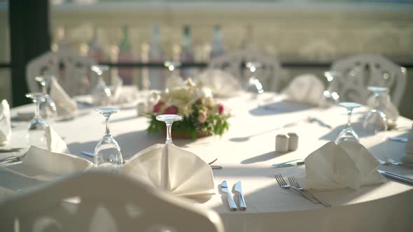 Place settings, Tables, And Chairs are Empty Before the Guests Arrive at a Wedding Reception alt