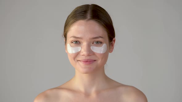 Beauty and skincare. Attractive smiling woman with under eye moisturizing patches mask