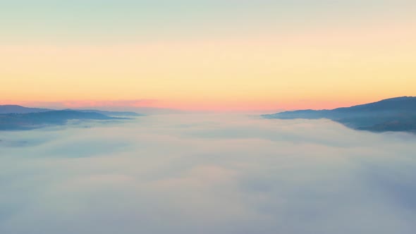 4K Aerial video Beautiful sunrise above dense clouds and fog in the morning alt