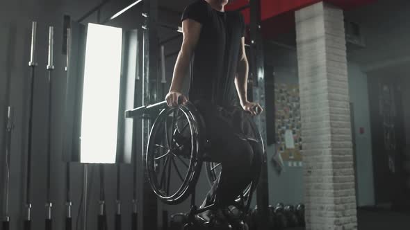 Workout Young Disabled Athlete in Wheelchair Performs Pushups on Bars Gym Training and Physical alt