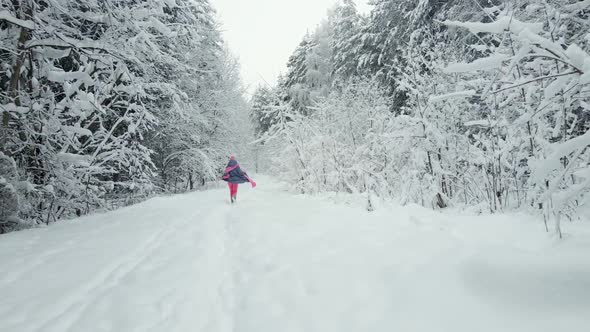 Traveler Woman in Pink Clothes a Scarf and a Hat and Sunglasses is Walking alt