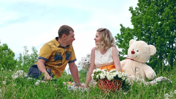 Couple Romantic In Love With Teddy bear Kissing outdoors.  alt