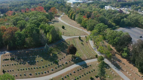 Aerial Drone Shot Tracking a Car Driving Through Mt Feake Cemetery in Waltham MA alt