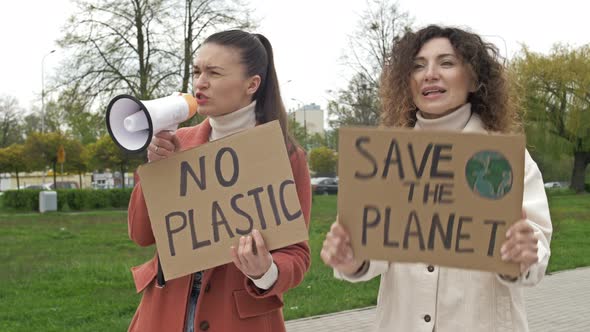 Two Women are Standing with Posters SAVE THE PLANET and NO PLASTIC