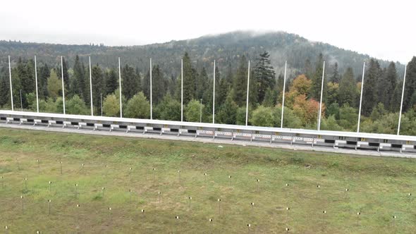 Biathlon sport training base with shooting range and sport lanes. alt