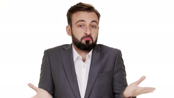 Portrait of Cunning Man in Suit Gesturing with Both Hands Meaning Oops Sorry Pretending He Has No alt