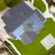 Aerial view of a rural private house with solar photovoltaic panels for producing clean electricity