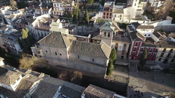 Aerial pan reveals quaint little Mudejar church next to Darro river, Granada