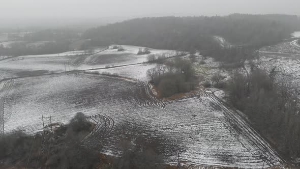 Fields With Snow During Winter Season Farming Concept Backwards Aerial alt