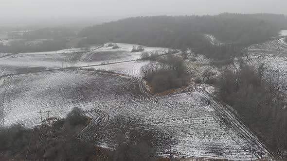 Fields With Snow During Winter Season Farming Concept Backwards Aerial