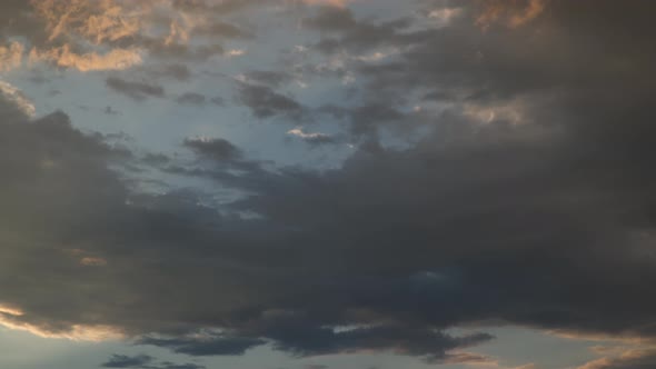 The movement of clouds at sunset. Dramatic sky. Time lapse