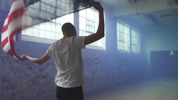 Fashionable young man in an abandoned warehouse alt