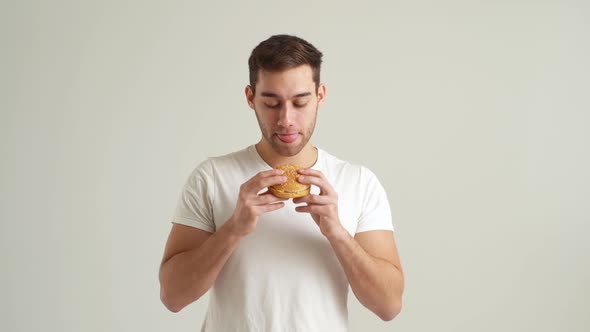 Studio Portrait of Hungry Handsome Young Man Licking His Lips and with Appetite to Eat Tasty on alt